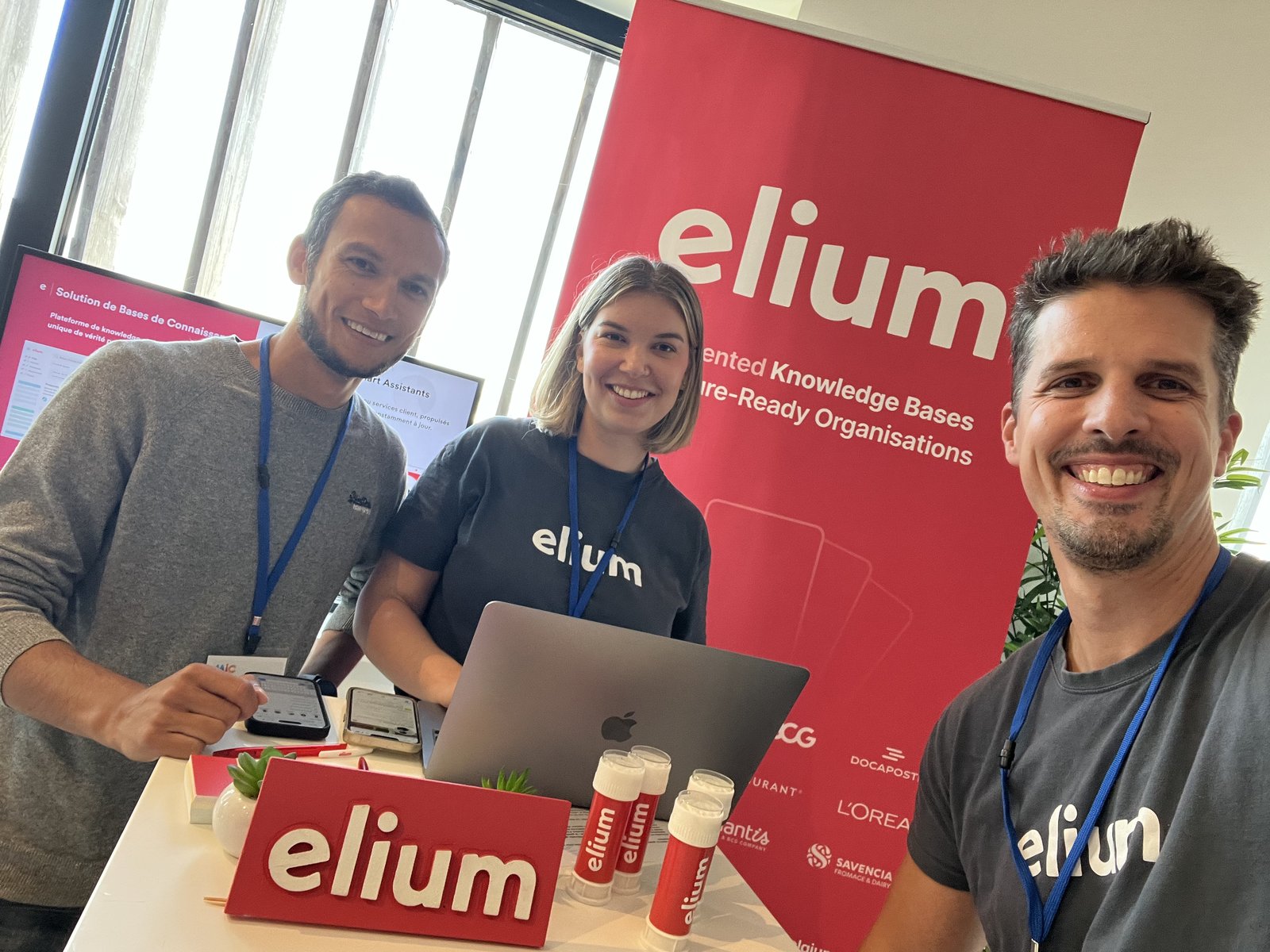 Three colleagues at the Elium stand during a trade show